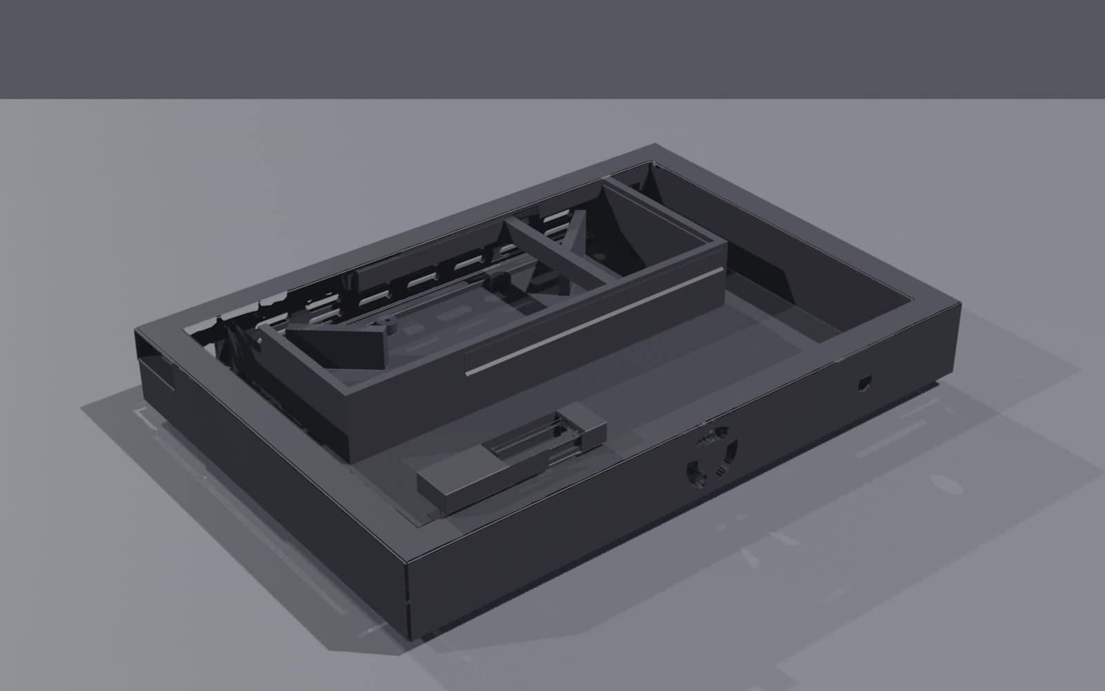Dock chassis with the lid removed, showing the fan bay, cable channels and NFC reader pocket